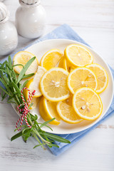 Sliced lemons and rosemary sprigs tied with kitchen string
