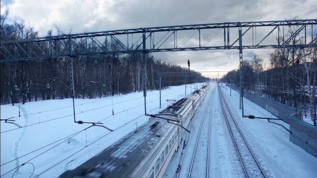 High-speed train is approaching and passes, at winter