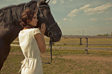 beautiful girl in a white gown with horse on nature