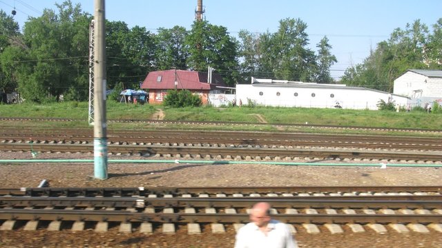 Pass by railroad station, view from window moving train