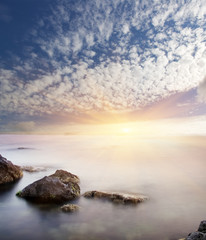 Fototapeta na wymiar Rock in sea on sunset.