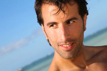 Handsome man standing on the beach