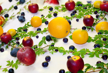 Fruits and leaves on a table (collage of several photos)