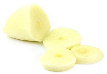 Sliced garlic on white background