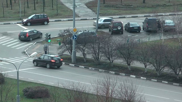 Movement of cars at a crossroads time lapse clip.