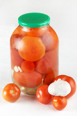 Glass jar with marinated tomatoes