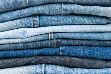 Stack of blue jeans background © peresanz