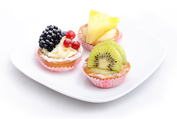 Three cakes on the plate. Isolated.