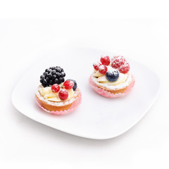 Two cakes on the plate. Isolated.