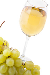 glass of white wine and white grapes on white