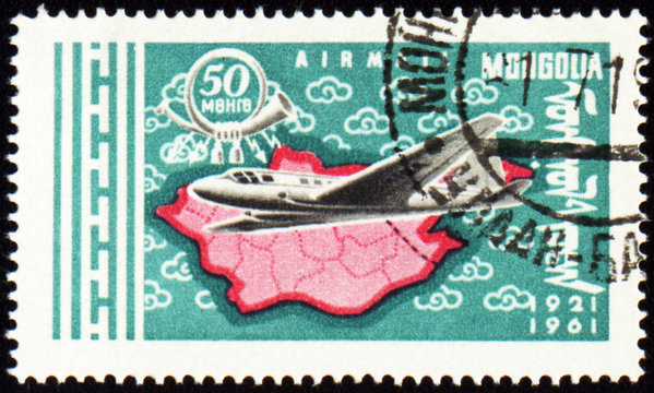 Flying air liner and map of Mongolia on post stamp