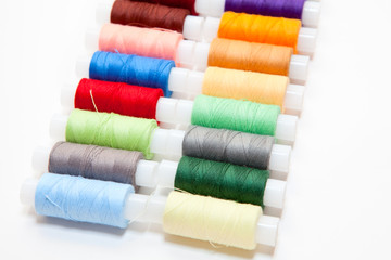 Colourful arranged reel of thread isolated on white