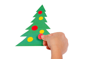 Creating Christmas tree of colored paper on a white background