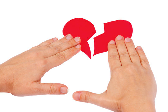 Hands combine broken red heart on a white background