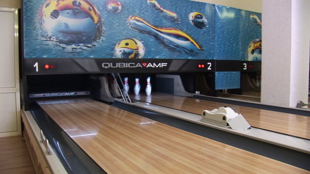 bowling ball knocks down pins