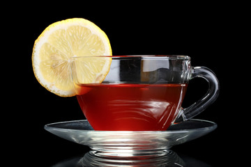 tea with lemon on black background