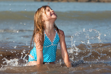 child playing in the ocean waves