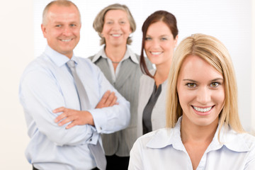 Business team young woman with mature colleagues
