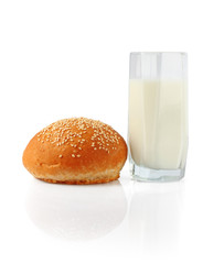 Milk in glass and roll