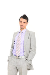 young business man standing with hands in pocket