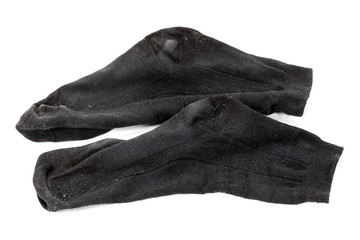 Грязные мужские носки на ссветлом фоне.