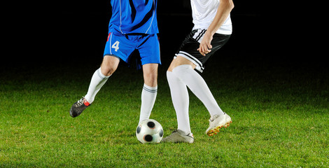 football players in action for the ball