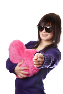 Beautiful brunette girl with toy heart.
