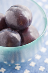 Glass bowl with plums