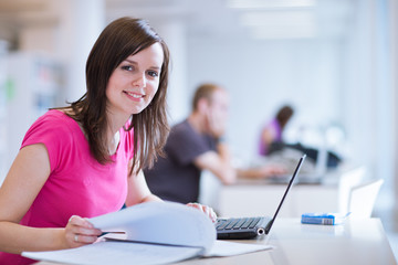 in the library - pretty female student with laptop