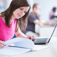 in the library - pretty female student with laptop