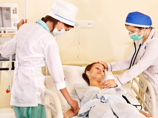 Obraz na płótnie Canvas Doctor treats patient with stethoscope.