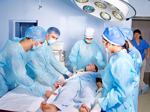 Woman on gurney in operating room.