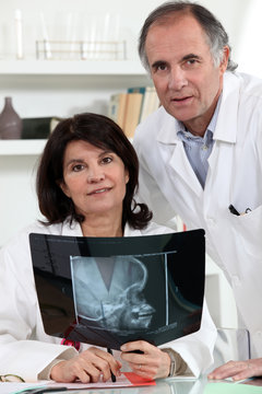 Two doctors examining x-ray image