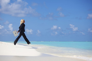 business woman jump in ocean