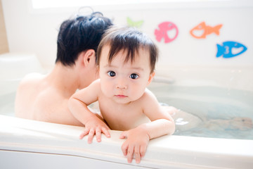 baby and father in bath