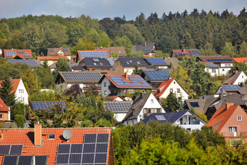 view on houses with solar thermal and photovoltaik roof systems