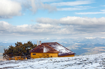 Wooden house on autumn mountain hill