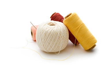 Thread bobbins on the white background
