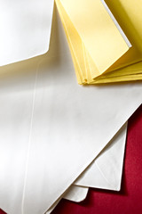 A pile of envelopes on the red background