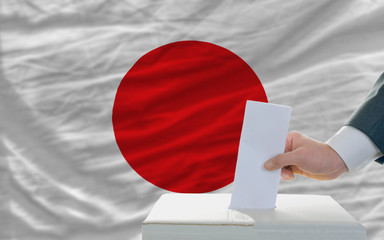 man voting on elections in japan