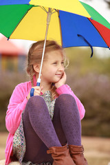 portrait of little girl with an color umbrella