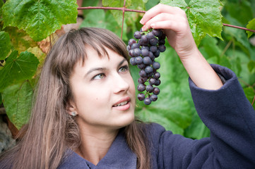 Young woman with grapes