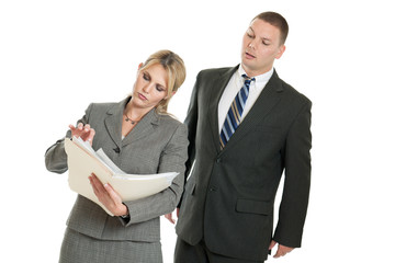 Business man looking over business woman's shoulder