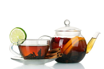 Glass teapot and cup with black tea of orange, cinnamon isolated