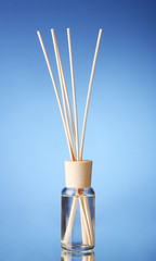 Bottle of air freshener on blue background