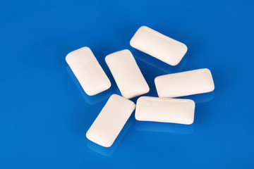 Chewing gums on blue background