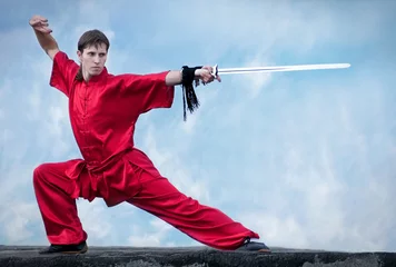 Zelfklevend Fotobehang Wushoo man in red practice martial art © mr.markin