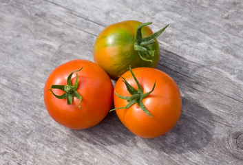 Fresh rural tomatoes on old wooden board