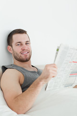 Fototapeta na wymiar Portrait of a handsome man reading a newspaper