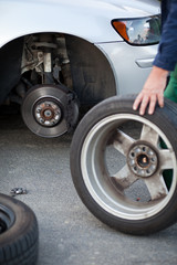 Obraz na płótnie Canvas mechanic changing a wheel of a modern car